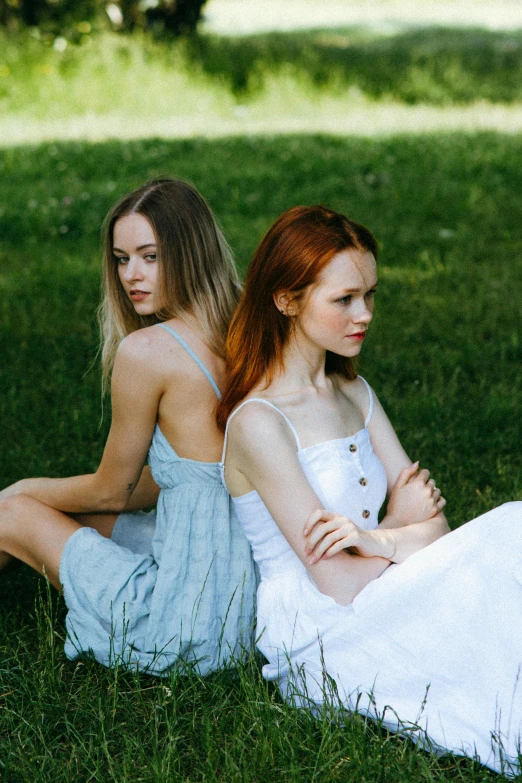 a couple of women sitting on top of a lush green field, trending on pexels, renaissance, sullen old maid ( redhead, delicate poses, 15081959 21121991 01012000 4k, sydney sweeney