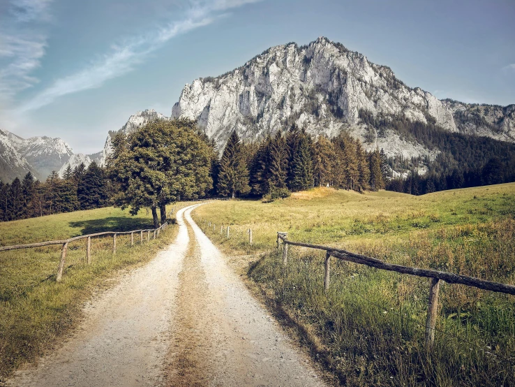 a dirt road with a mountain in the background, pexels contest winner, renaissance, sound of music, limestone, youtube thumbnail, delightful surroundings