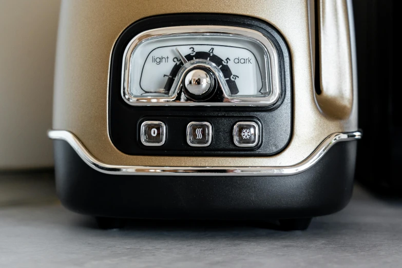 a close up of a toaster on a counter, by Julian Allen, process art, dials, clear [bronze] face, light tan, 3 colours