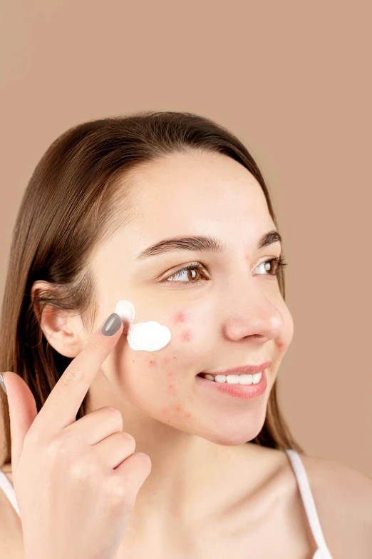 a woman putting cream on her face, a digital rendering, trending on pexels, scar on the cheek, manuka, square, handmade