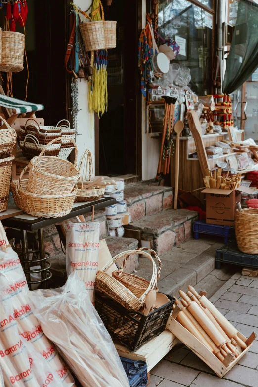 a bunch of baskets that are on a table, a picture, trending on unsplash, dreamy chinese town, tools and junk on the ground, shop front, square