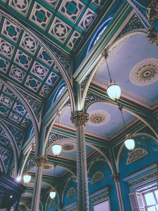 an ornately decorated ceiling in a building, inspired by Sydney Prior Hall, unsplash contest winner, blue and green color scheme, 2 5 6 x 2 5 6 pixels, style of wes anderson, gothic lighting