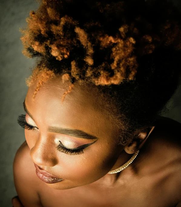 a close up of a woman with an afro, by Chinwe Chukwuogo-Roy, pexels contest winner, gold eyeshadow, soft lighting from above, curly copper colored hair, glamor profile pose