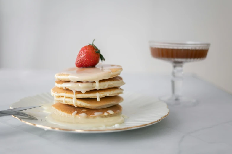 a stack of pancakes with syrup and a strawberry on top, a portrait, unsplash, pearl silverplate, flan, background image, white