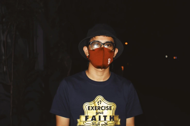 a man wearing a face mask in the dark, inspired by Eddie Mendoza, wearing sunglasses and a cap, the earth, maroon, jakarta