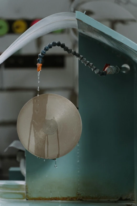 a sink with a faucet running out of it, an engraving, by Attila Meszlenyi, kinetic art, in a factory, circular, medium level shot, made of liquid metal and marble