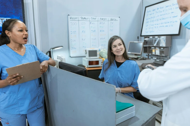 a couple of women standing next to each other in a room, scrubs, profile image, grey, gray