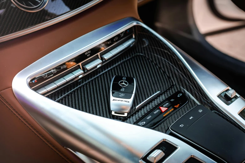 a close up of a car dashboard with a remote control, luxury materials, thumbnail, f / 2 0, mercedes