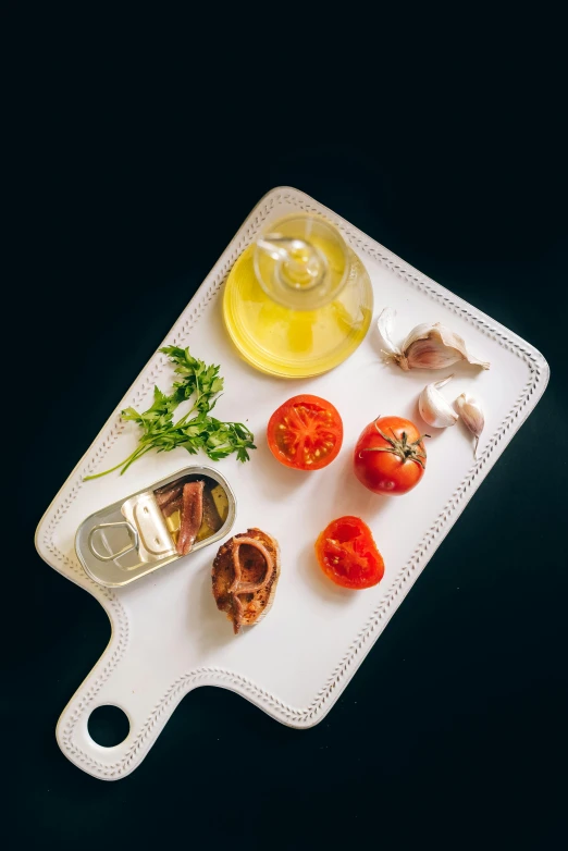 a cutting board with a variety of ingredients on it, by Adam Marczyński, pexels contest winner, hyperrealism, sardine in a can, tomato, mediterranean, plating