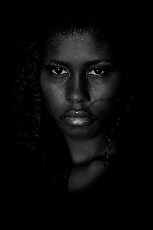 a close up of a person's face in the dark, a black and white photo, inspired by Lee Jeffries, renaissance, somali woman, looking serious, photo of young woman, african domme mistress