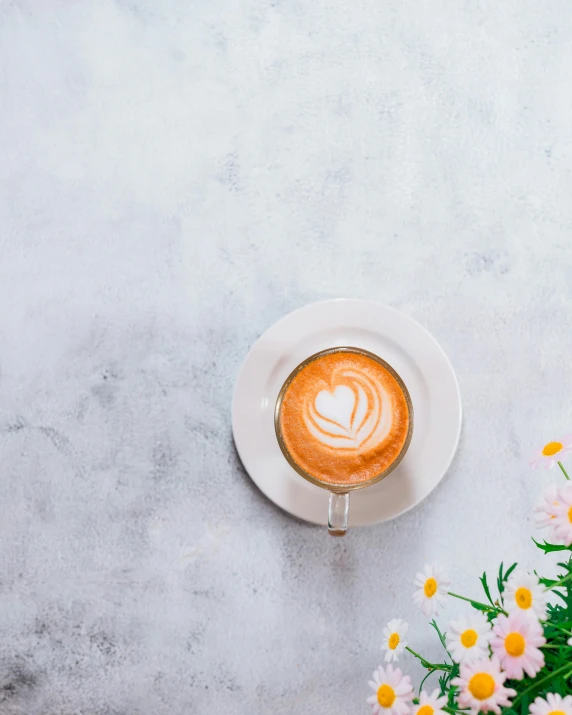 a cup of coffee sitting on top of a table, by Lucia Peka, trending on unsplash, chamomile, lgbtq, background image, multiple stories