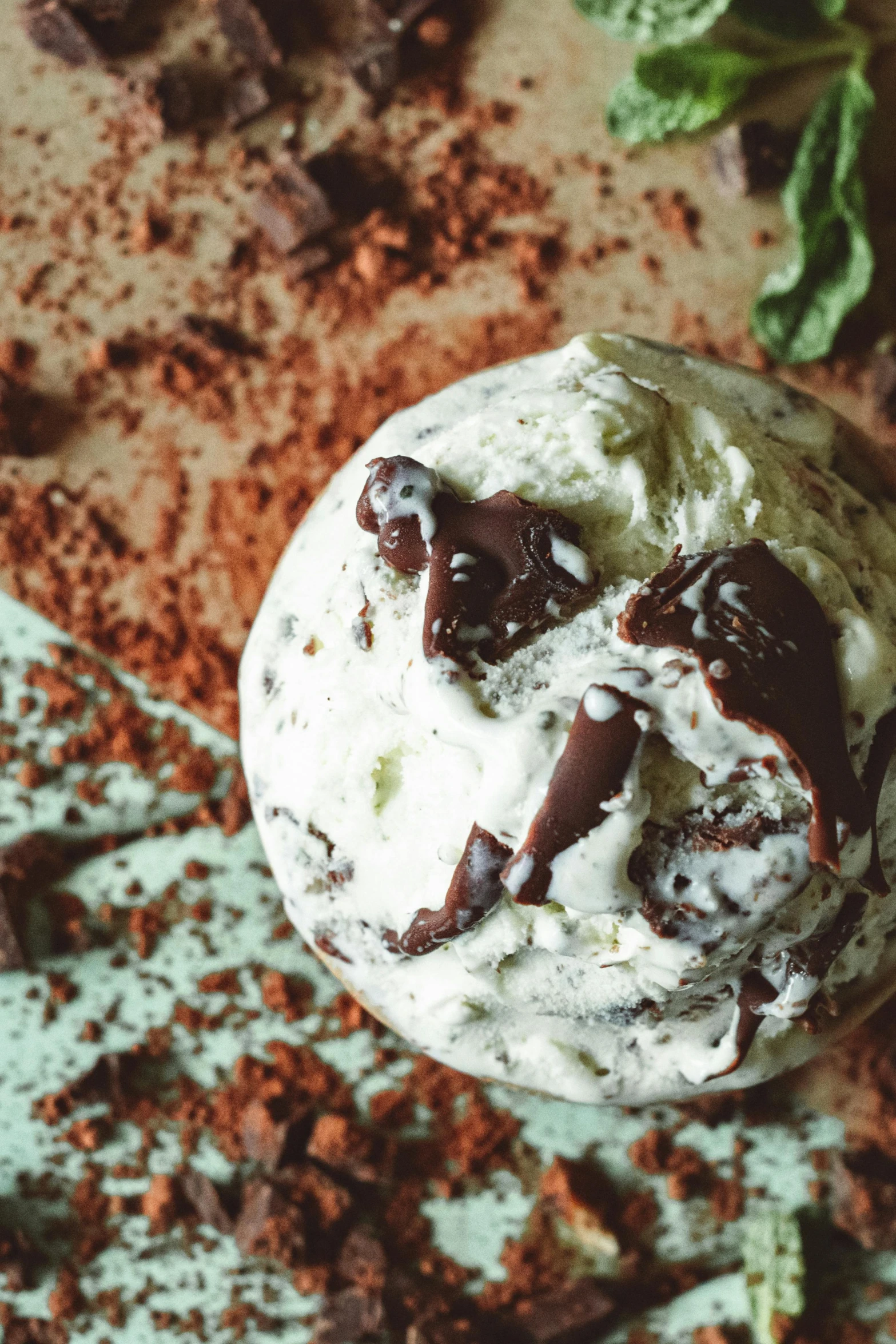 a scoop of ice cream sitting on top of a table, basil, chocolate river, detailed product image, epicurious