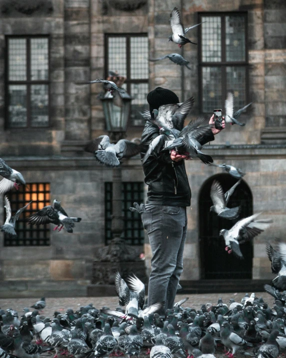 a man standing in front of a flock of pigeons, by Jan Tengnagel, pexels contest winner, interactive art, lgbtq, casting a protection spell, mittens, doves : : rococo