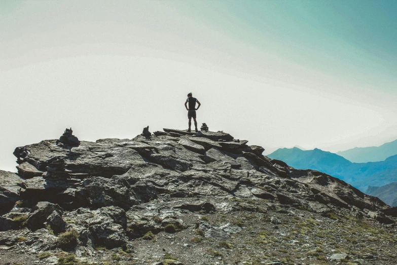 a man standing on top of a rocky mountain, by Niko Henrichon, outdoor photo, whistler