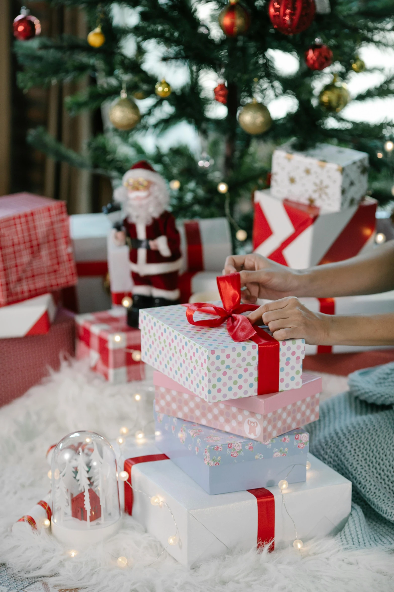 a woman opening presents in front of a christmas tree, by Julia Pishtar, happening, high angle close up shot, promo image, bows, thumbnail