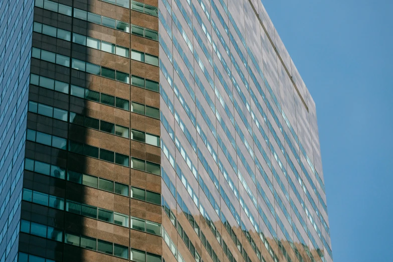 a couple of tall buildings next to each other, by William Berra, pexels contest winner, modernism, aquamarine windows, brown, corporate business, three - quarter view