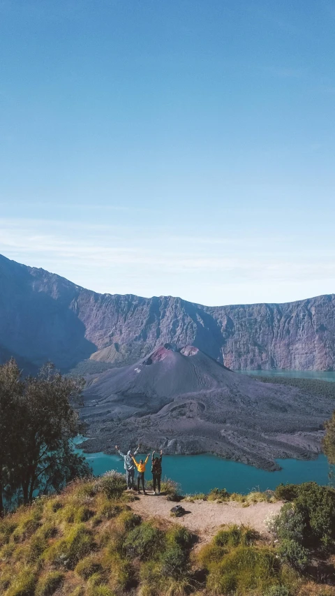 a couple of people standing on top of a mountain, by Kogan Gengei, trending on unsplash, sumatraism, crater lake, low quality photo, fuji superia, square