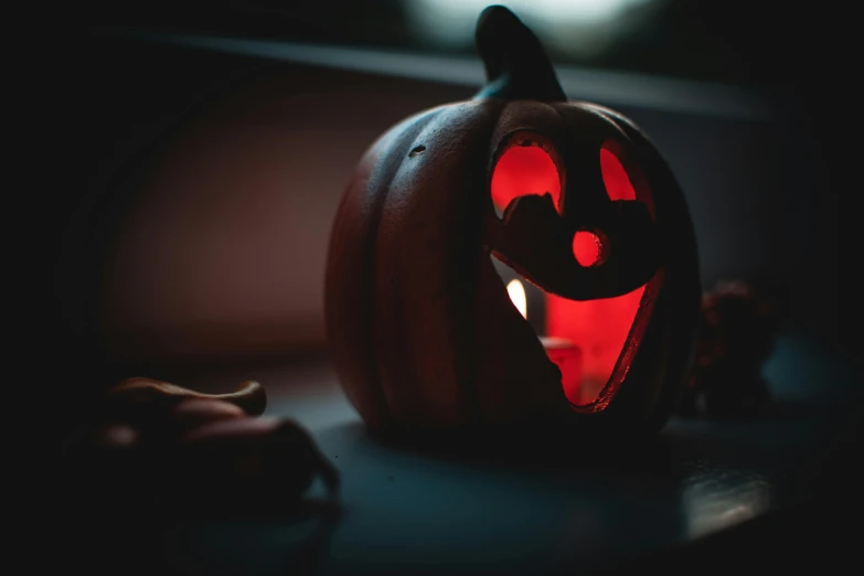 a halloween pumpkin sitting on top of a table, pexels contest winner, glowing red, profile image, glowing mouth, lantern
