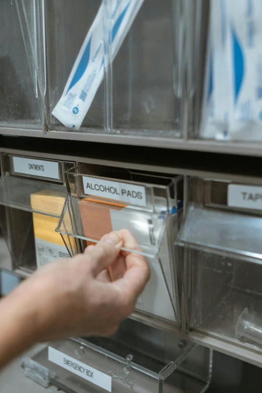 a person putting toothbrushes in a dispenser, by Jason Felix, happening, refrigerated storage facility, labels, brown, apothecary