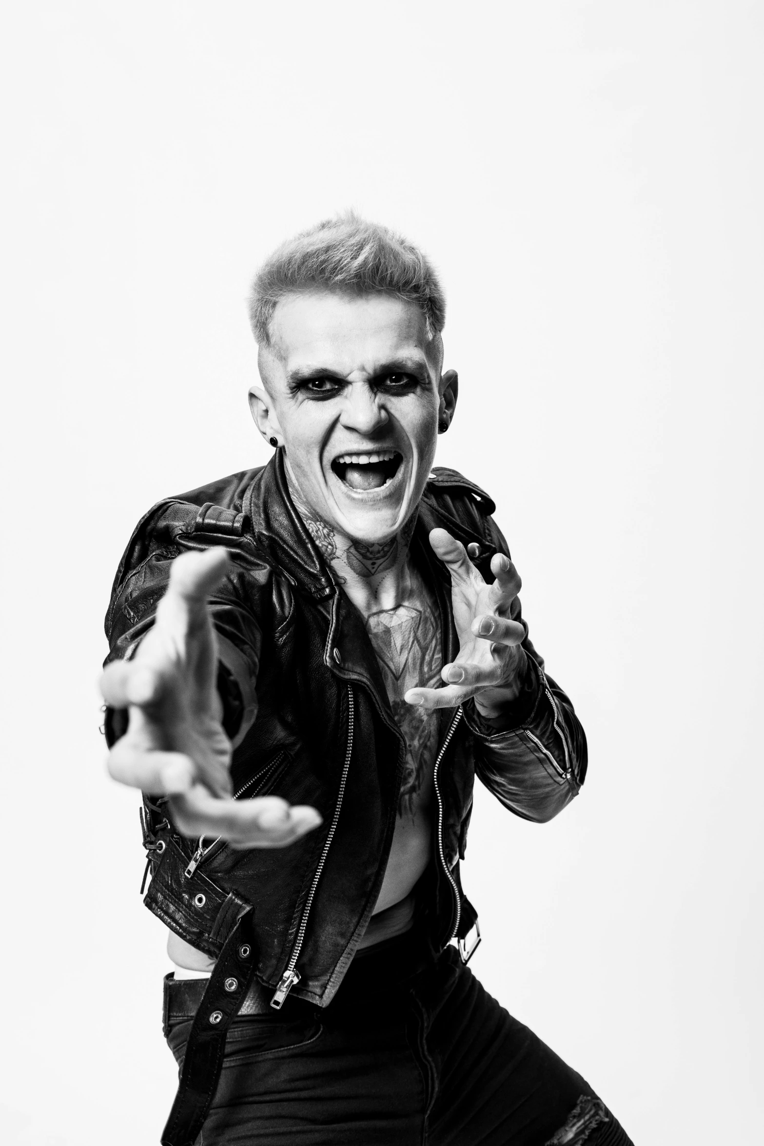 a black and white photo of a man in a leather jacket, a black and white photo, inspired by Seb McKinnon, is evil gremlin, justin bieber, angry smile, square