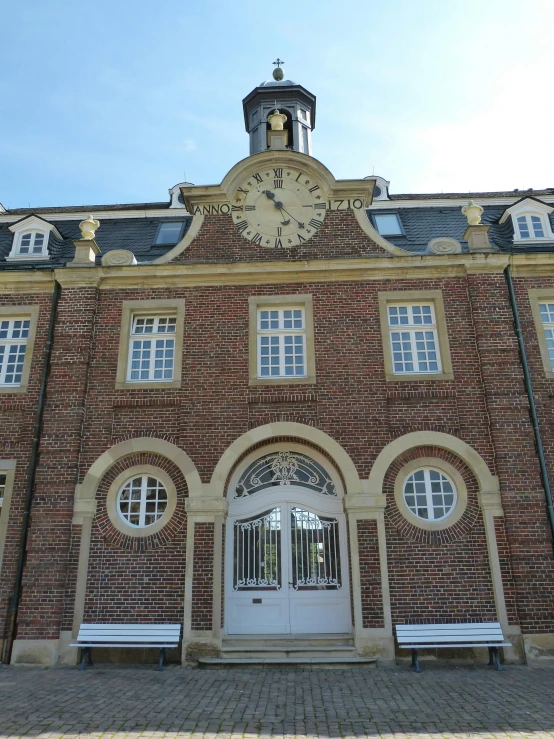 a large brick building with a clock on the front, inspired by Albert Paris Gütersloh, heidelberg school, private academy entrance, gold, lots de details, rennes - le - chateau