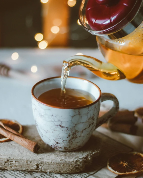 a person pouring tea into a cup, by Julia Pishtar, trending on pexels, renaissance, cinnamon skin color, square, made of honey, festive