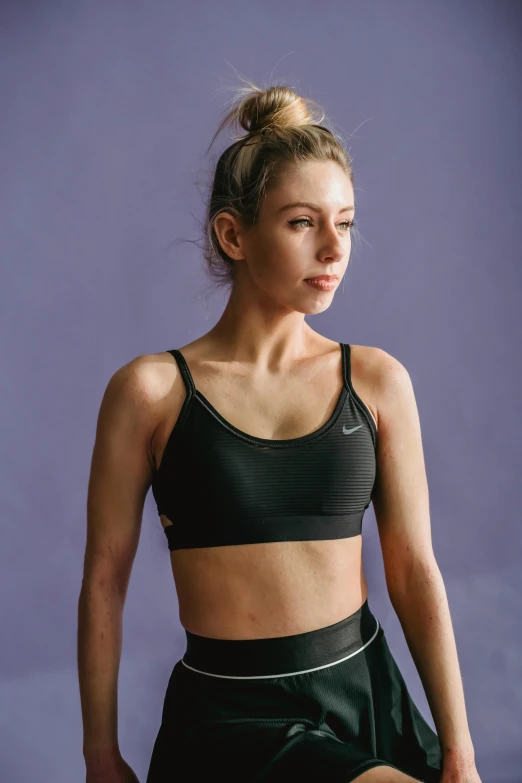 a woman in a black sports bra top and black shorts, inspired by Louisa Matthíasdóttir, profile image, promo image, wearing a cropped tops, hypersphere