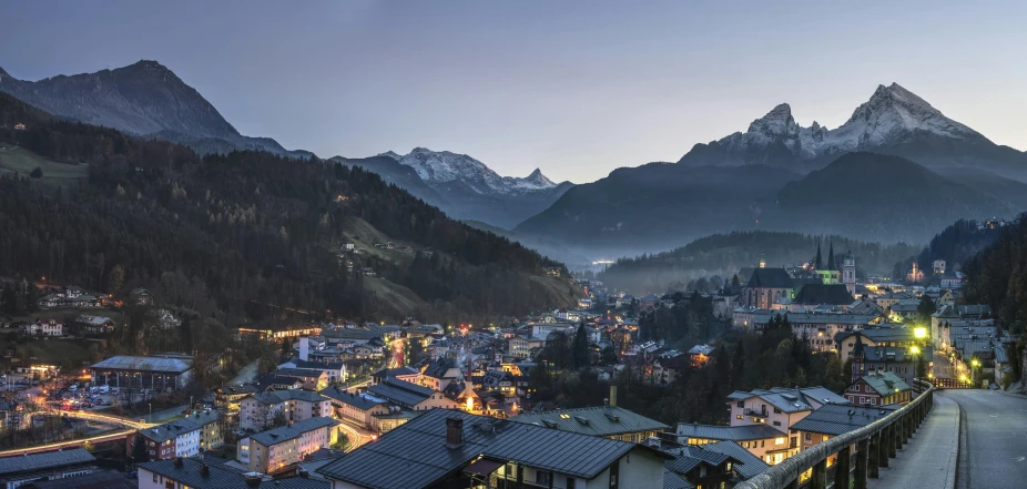 a view of a town with mountains in the background, by Tobias Stimmer, pexels contest winner, blue hour, square, detailed high resolution, psychedelic ski resort