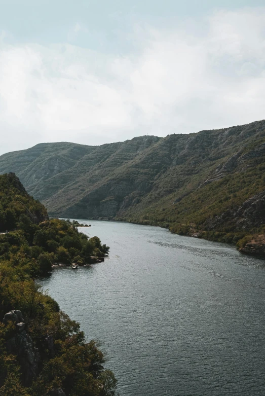 a river running through a lush green hillside, by Jesper Knudsen, pexels contest winner, hurufiyya, 2 5 6 x 2 5 6 pixels, overcast lake, portugal, mountains river trees