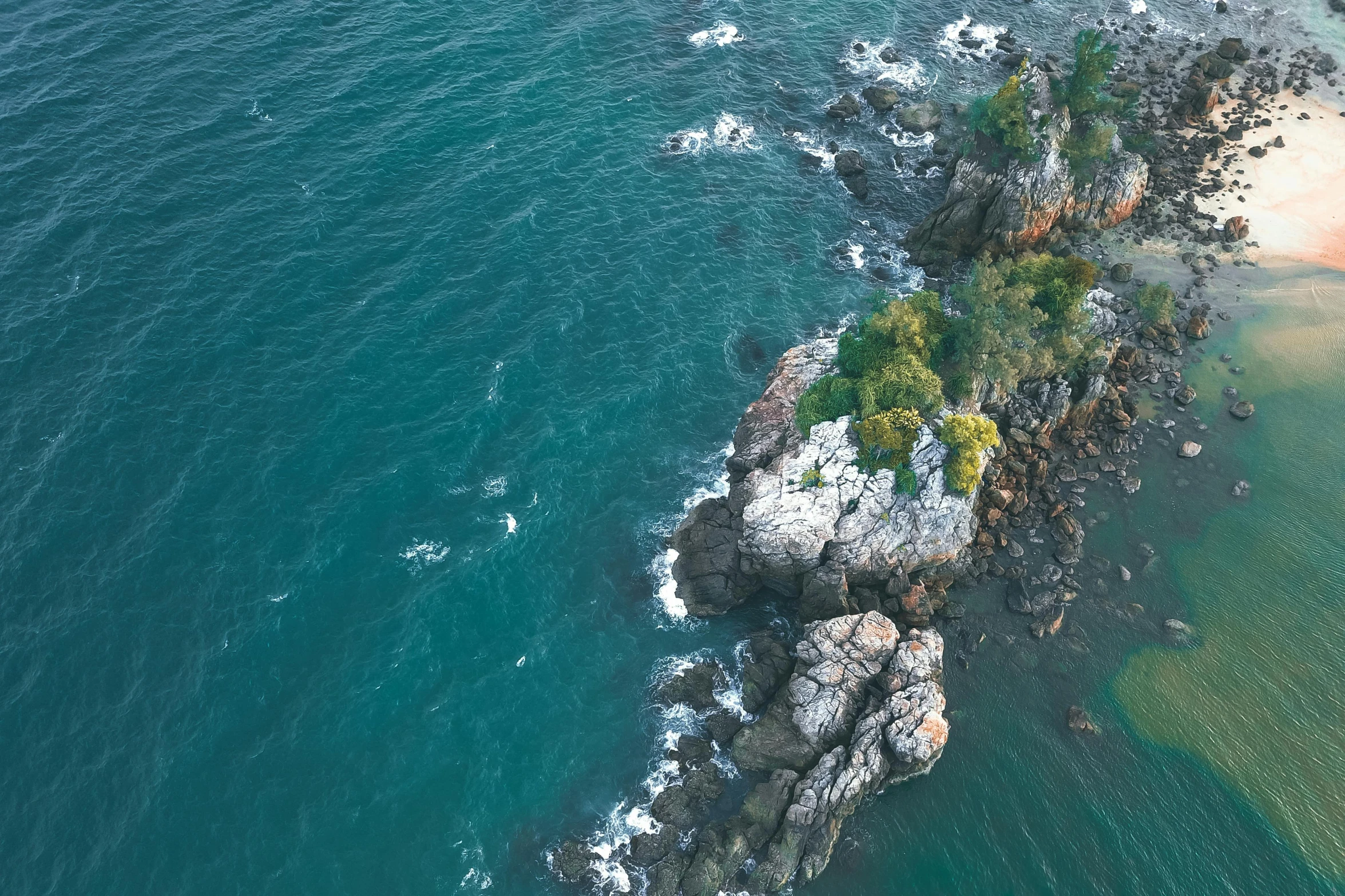 a small island in the middle of the ocean, pexels contest winner, rocky cliff, top down perspecrive, thumbnail, manly