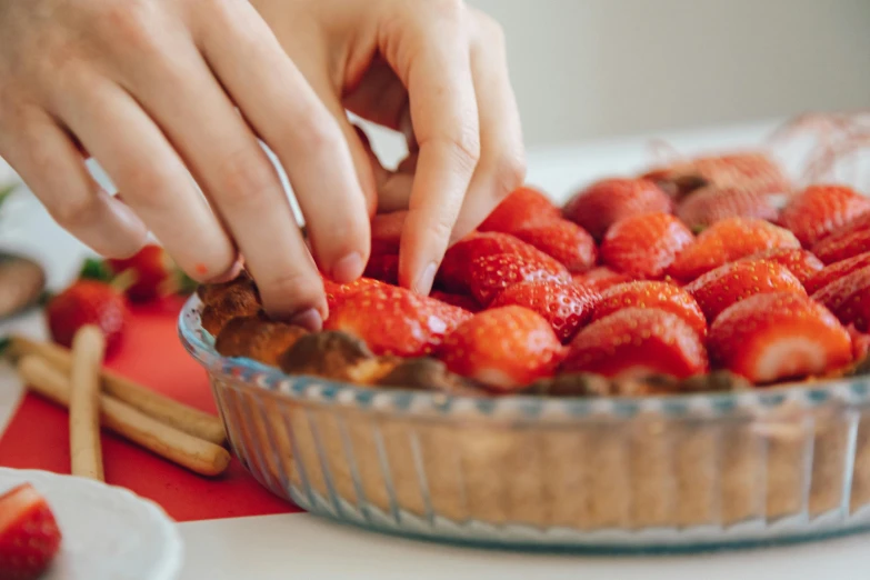 a close up of a person putting strawberries in a pie, pexels contest winner, 🦩🪐🐞👩🏻🦳, candy treatments, best practice, beautifully daylight