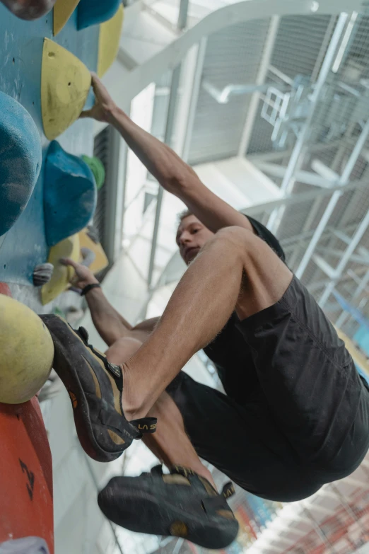 a man is climbing on a rock wall, happening, central hub, shot with sony alpha 1 camera, film still of manny pacquiao, instagram picture