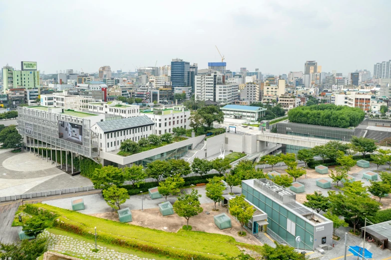 a view of a city from the top of a building, a picture, by Jang Seung-eop, grass field surrounding the city, museum photo, square, high quality upload