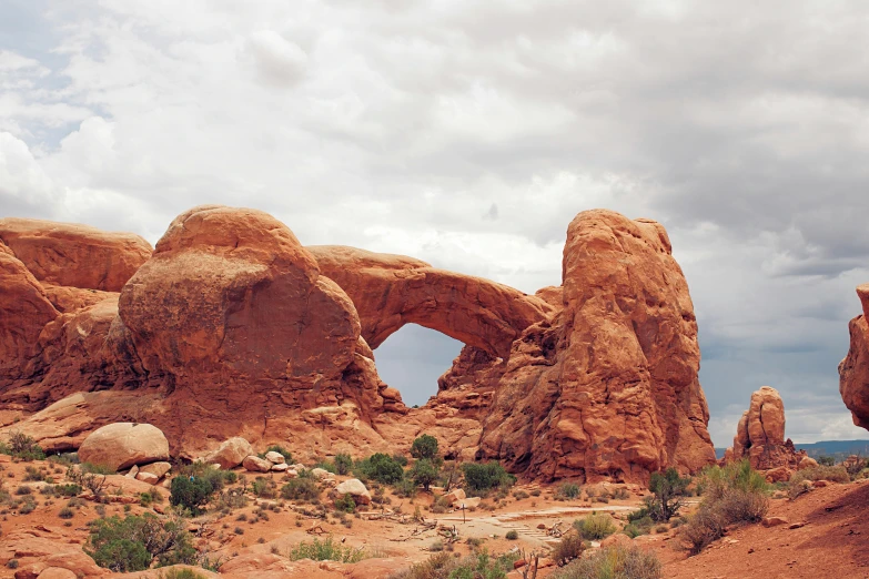 a large rock formation in the middle of a desert, a colorized photo, by Morgan Russell, unsplash contest winner, tall arches, wide windows, viewed from a distance, 2000s photo