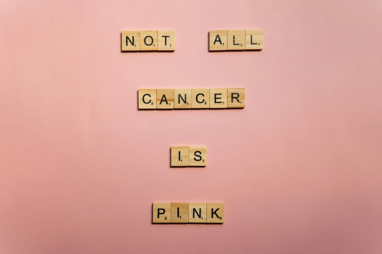 a pink refrigerator with scrabbles spelling not all cancer is pink, a photo, pexels, wood print, 3 4 5 3 1, tans, gray