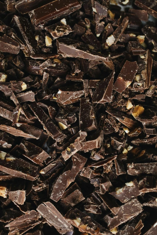 a pile of pieces of chocolate sitting on top of a table, by Jessie Algie, close-up print of fractured, thumbnail, full frame image, herbs