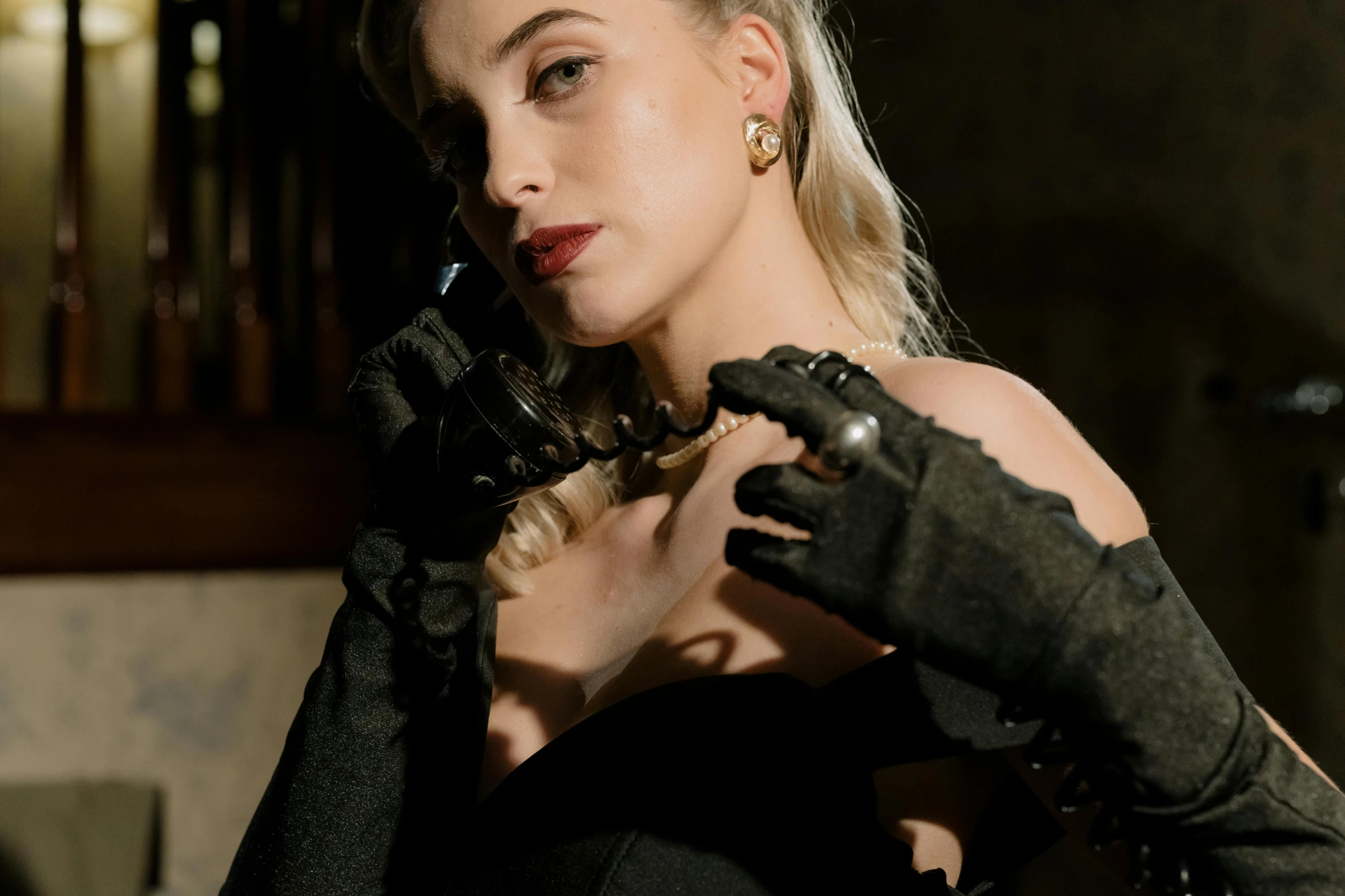 a woman in a black dress and black gloves, by Emma Andijewska, trending on pexels, renaissance, girl making a phone call, wearing steampunk attire, wearing jewellery, sydney sweeney