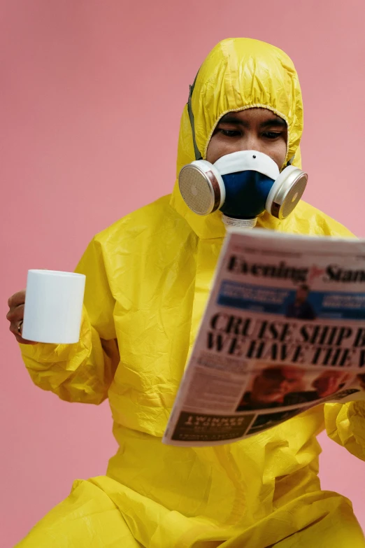 a man in a yellow hazmat suit reading a newspaper, by Julia Pishtar, pexels contest winner, coffee smell, gif, coat for a rave, flooding