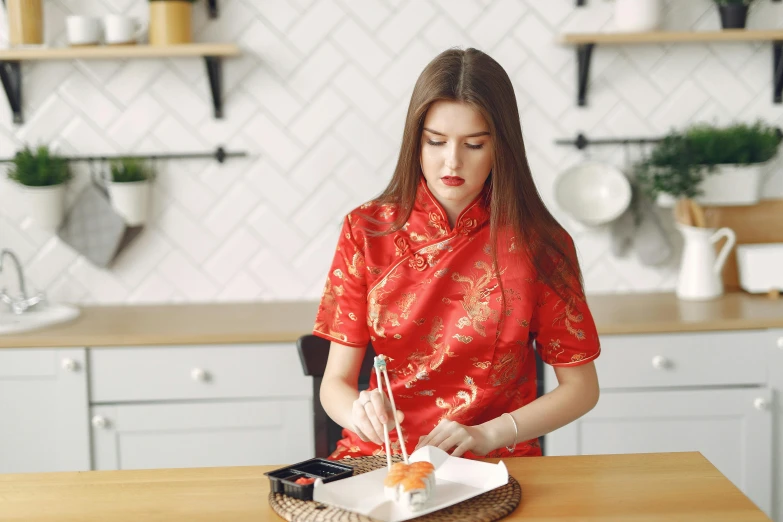 a woman in a red dress is eating sushi, inspired by Zhou Shuxi, trending on pexels, art nouveau, on kitchen table, embroidered robes, 15081959 21121991 01012000 4k, 21 years old