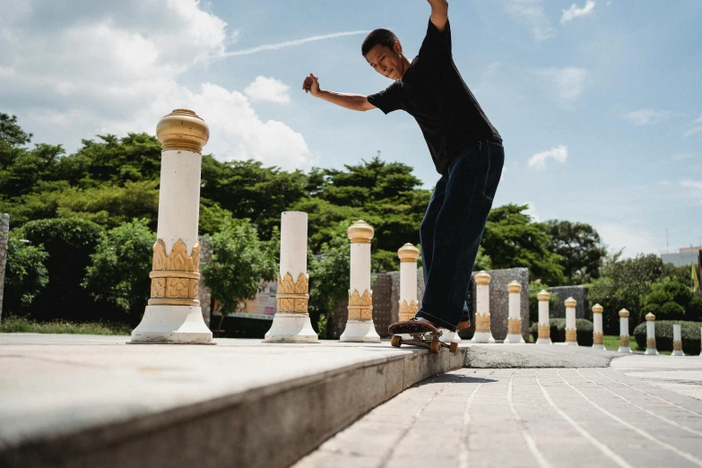 a man riding a skateboard down a set of steps, a picture, by Dan Content, unsplash contest winner, realism, pillars and arches, malaysian, standing over a tomb stone, in the style of sifu 🔥 😎 🕹️ 👀 :2