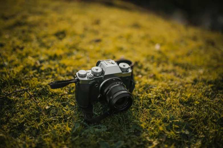 a camera sitting on top of a lush green field, a picture, fujifilm x - t 4, fan favorite, uploaded, medium format