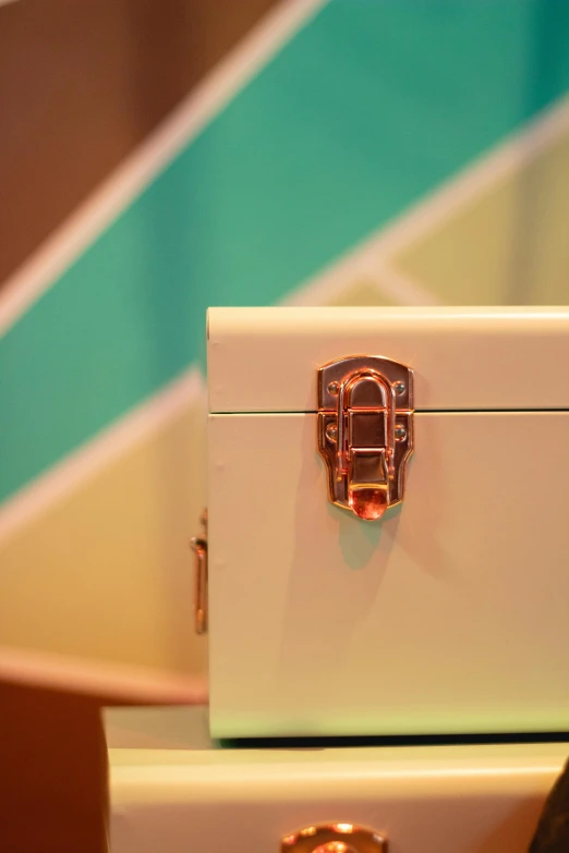 a couple of suitcases sitting on top of each other, inspired by Wes Anderson, unsplash, cloisonnism, detail shot, ivory and copper, box, multicoloured