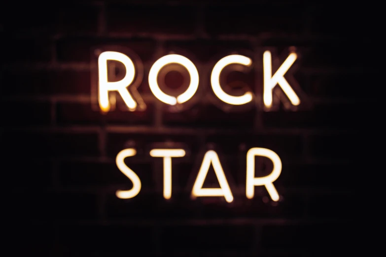 a neon sign that says rock star on a brick wall, an album cover, by Julia Pishtar, shutterstock, himalayan rocksalt lamp, the band name is roborock, profile pic, lucky star