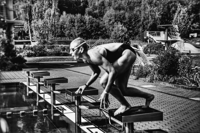 a black and white photo of a statue of a man, a black and white photo, by Dietmar Damerau, purism, playing at swiming pool, carole feuerman, 🔥 😎 🕹️ 👀 :2, leon tukker