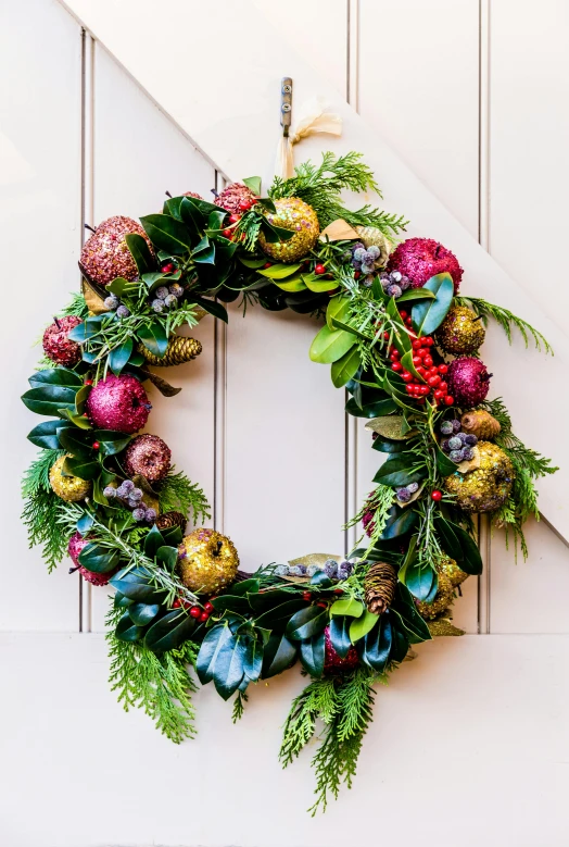 a close up of a wreath on a door, a photo, by Nancy Graves, shutterstock, baroque, with lots of thin ornaments, colorful”, photo of a beautiful, throw