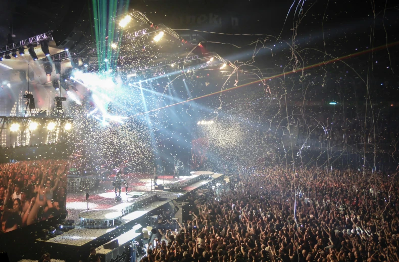 a large crowd of people at a concert, a screenshot, pexels contest winner, exploding roses, floor b2, kiss, 3 / 4 wide shot