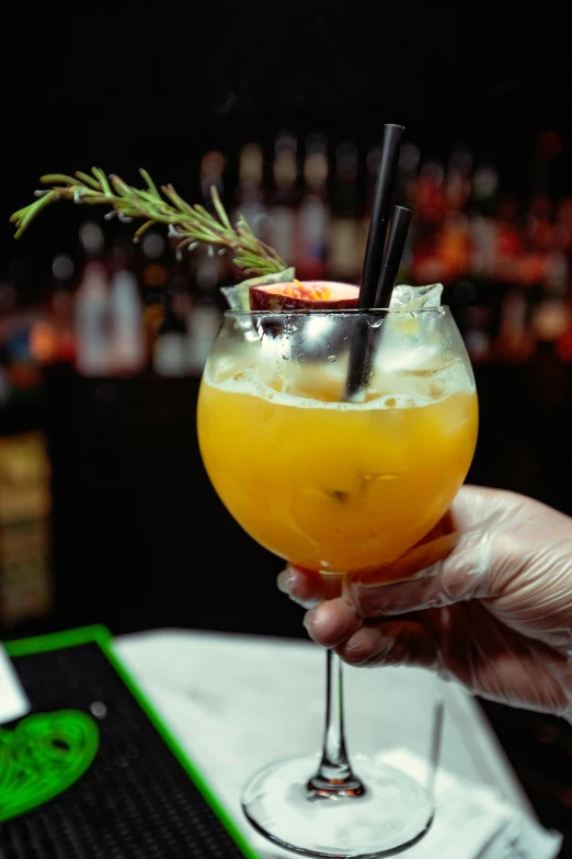 a person holding a glass with a drink in it, peach, thumbnail, arrendajo in avila pinewood, nightlife