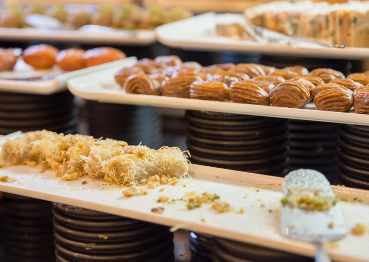 a buffet filled with lots of different types of food, a picture, unsplash, hurufiyya, caramel, greek ameera al taweel, in a row, battered