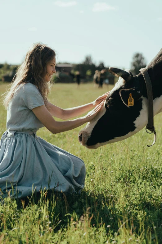 a woman is petting a cow in a field, by Emma Andijewska, cinematic, milk, **cinematic, college