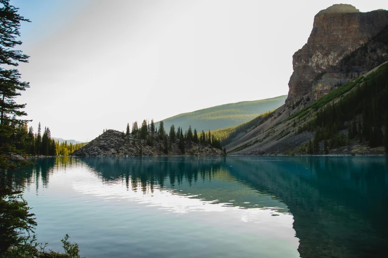 a body of water surrounded by trees and mountains, borealis, fan favorite, rock quarry location, postprocessed